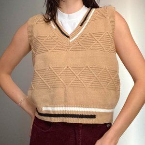 Tan sweater vest with black and white detaling